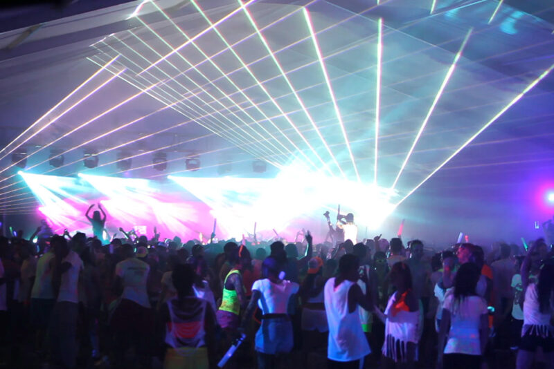 Crowd of people at a concert inside a giant tent.